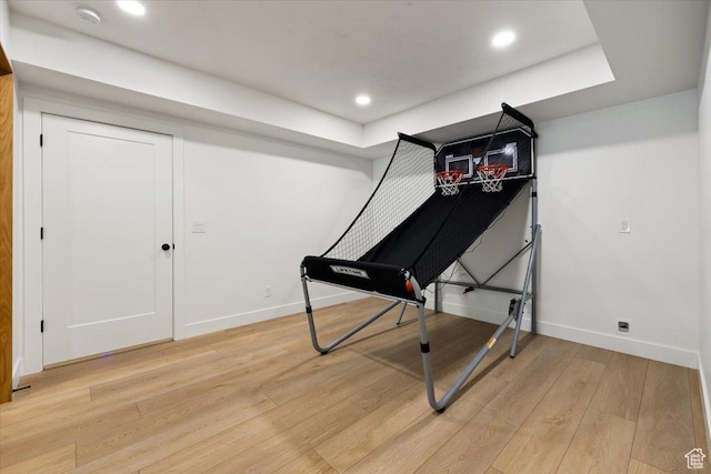 workout area with light wood finished floors, baseboards, and recessed lighting