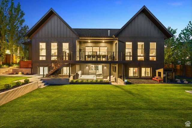 back of house featuring board and batten siding and stairs