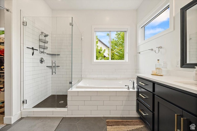 full bath with tile patterned flooring, a stall shower, a garden tub, and vanity