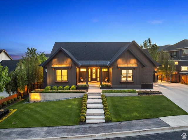 modern farmhouse style home featuring board and batten siding, covered porch, a standing seam roof, and metal roof