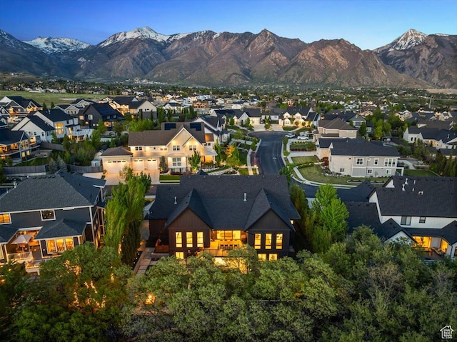 aerial view of property's location with nearby suburban area and a mountainous background