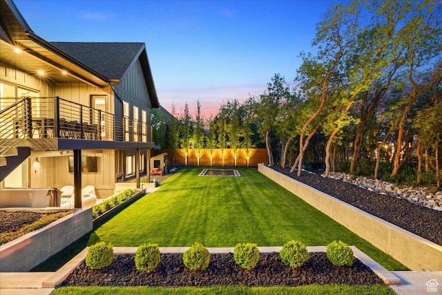 yard at dusk with a balcony