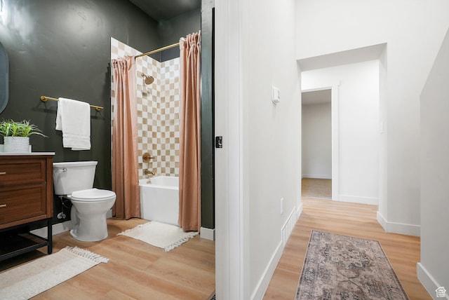 3670 S 1300 E, Millcreek, UT 84106 - bathroom with wood finished floors, toilet, shower / bathtub combination with curtain, vanity, and baseboards