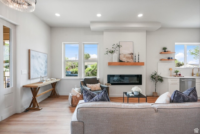 3670 S 1300 E, Millcreek, UT 84106 - living room with plenty of natural light, light wood-style flooring, a glass covered fireplace, recessed lighting, and baseboards