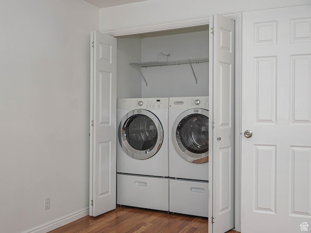 washroom featuring washer and clothes dryer and dark wood-type flooring