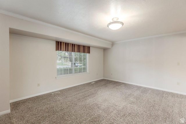 carpeted empty room with ornamental molding and baseboards