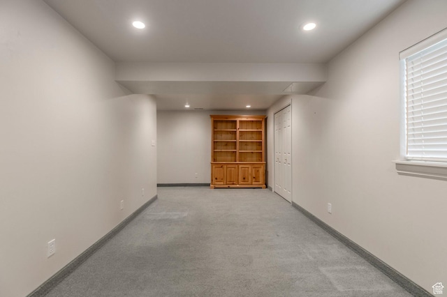 corridor featuring light colored carpet, recessed lighting, and baseboards
