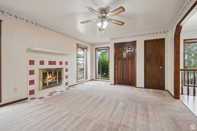 2268 W 5300 S, Roy, UT 84067 - unfurnished living room featuring carpet floors, a ceiling fan, a fireplace with flush hearth, and baseboards