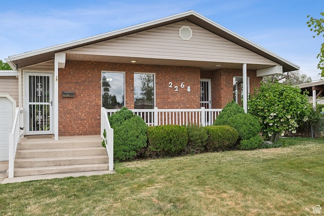 2268 W 5300 S, Roy, UT 84067 - view of front of property featuring a front lawn, brick siding, and a porch