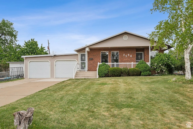 2268 W 5300 S, Roy, UT 84067 - view of front of property with concrete driveway, covered porch, a garage, a front lawn, and brick siding