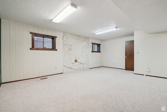 2268 W 5300 S, Roy, UT 84067 - below grade area with a textured ceiling, carpet flooring, wooden walls, and baseboards