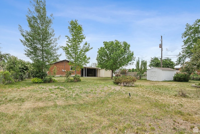 2268 W 5300 S, Roy, UT 84067 - view of grassy yard with a storage unit, an outdoor structure, and a sunroom
