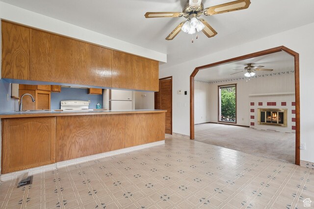 2268 W 5300 S, Roy, UT 84067 - kitchen featuring light floors, a ceiling fan, white appliances, brown cabinets, and a sink