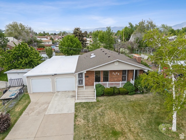 2268 W 5300 S, Roy, UT 84067 - ranch-style home featuring a porch, an attached garage, concrete driveway, brick siding, and a front yard