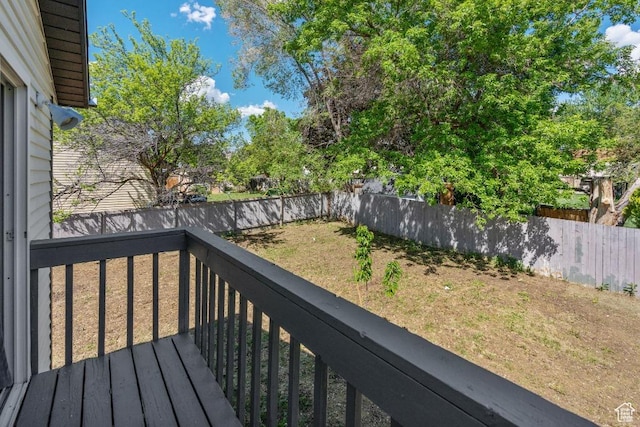 wooden deck featuring a fenced backyard