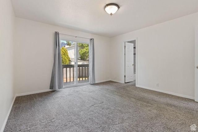 empty room with baseboards and carpet flooring