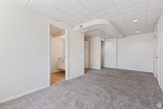 carpeted spare room featuring baseboards and recessed lighting