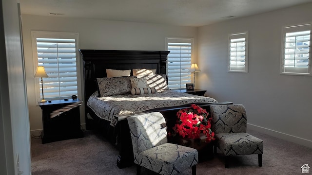 bedroom featuring carpet and baseboards