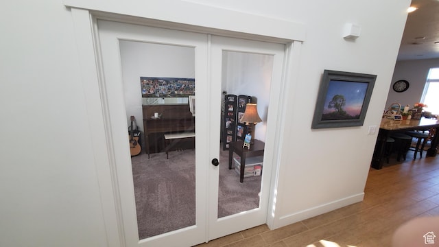 hallway with baseboards, wood finished floors, and recessed lighting