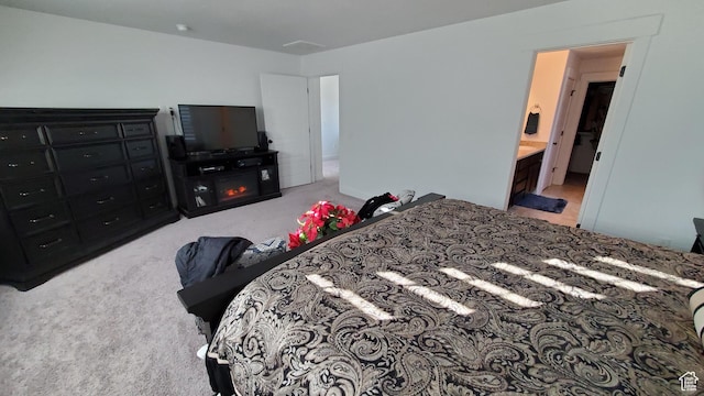 bedroom featuring light colored carpet