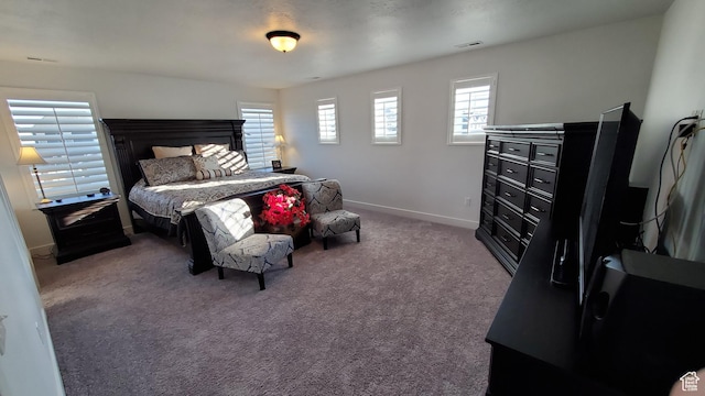 carpeted bedroom featuring baseboards