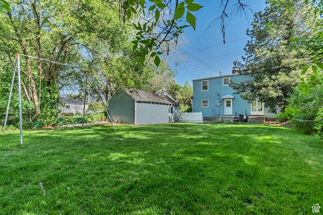 view of yard with an outdoor structure, entry steps, and a shed