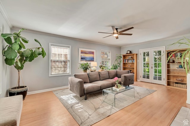 living area with wood finished floors, crown molding, a ceiling fan, french doors, and baseboards