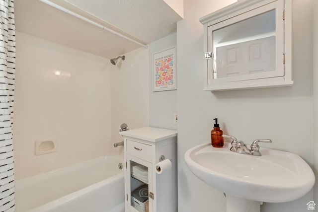 bathroom featuring bathing tub / shower combination and a sink