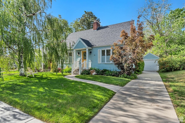 cape cod home with a front yard, roof with shingles, a chimney, and a detached garage