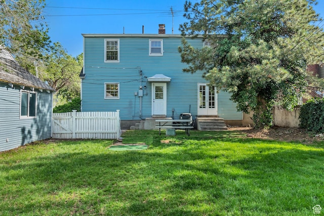 rear view of house featuring a chimney