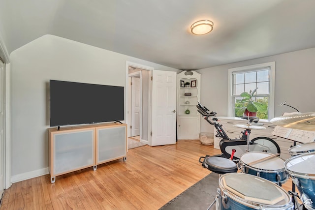exercise area with wood finished floors and baseboards