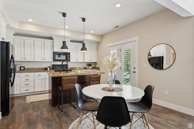 82 E Danta Dr S, Draper, UT 84020 - kitchen featuring black appliances, dark wood-style flooring, a center island with sink, white cabinetry, and recessed lighting