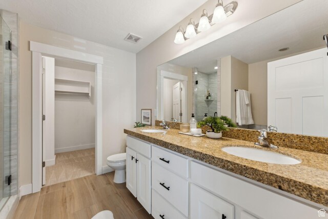 82 E Danta Dr S, Draper, UT 84020 - full bathroom with a shower stall, toilet, double vanity, baseboards, and wood finished floors