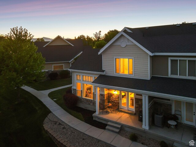 82 E Danta Dr S, Draper, UT 84020 - back of property with a patio area, central air condition unit, a shingled roof, and stone siding