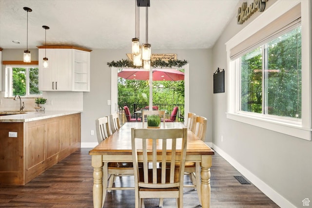 dining room with dark wood finished floors and baseboards