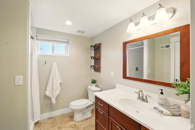 bathroom featuring toilet, curtained shower, vanity, and baseboards