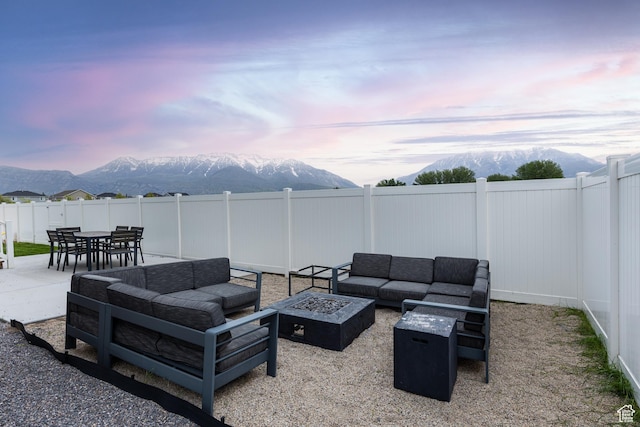 57 S Sterling Way, Vineyard, UT 84059 - view of patio with a mountain view, an outdoor living space with a fire pit, and a fenced backyard