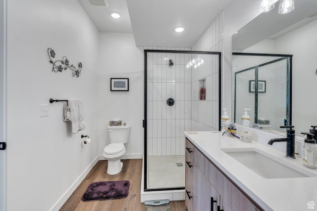 1218 S Sawmill Blvd Unit 1-106, Heber City, UT 84032 - bathroom featuring wood finished floors, toilet, a stall shower, vanity, and baseboards