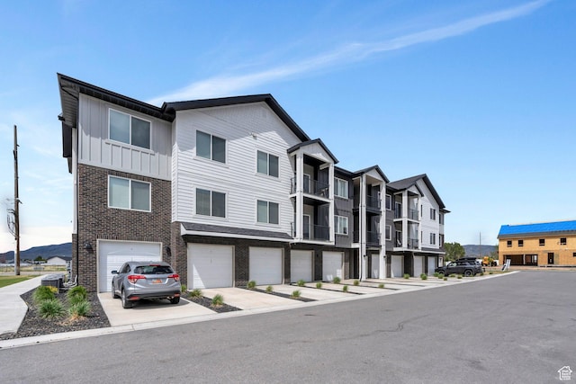 1218 S Sawmill Blvd Unit 1-106, Heber City, UT 84032 - view of building exterior featuring driveway and a garage