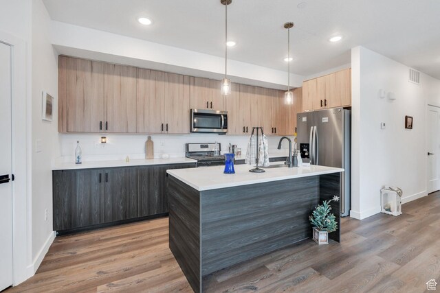 1218 S Sawmill Blvd Unit 1-106, Heber City, UT 84032 - kitchen with stainless steel appliances, light brown cabinetry, light countertops, light wood-style floors, and recessed lighting