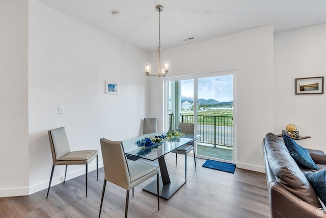 1218 S Sawmill Blvd Unit 1-106, Heber City, UT 84032 - dining space featuring a chandelier, wood finished floors, baseboards, and a mountain view