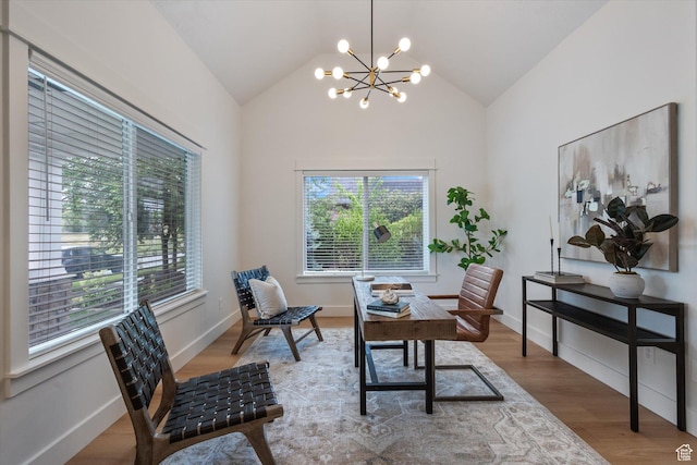 office space with a chandelier, vaulted ceiling, wood finished floors, and baseboards