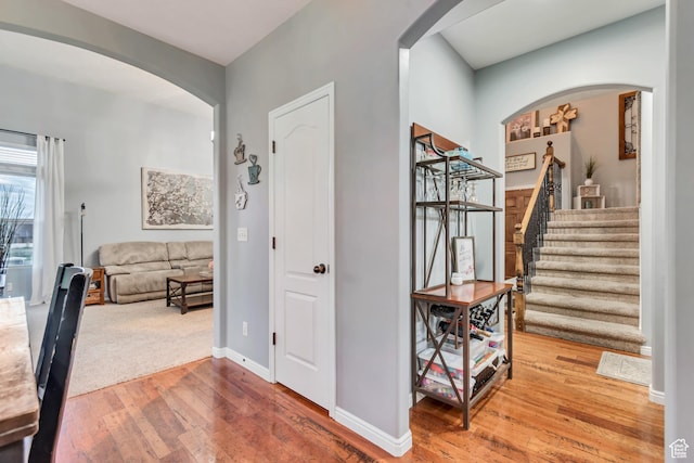 5414 W Island Creek Dr S, West Jordan, UT 84081 - hall featuring arched walkways, hardwood / wood-style flooring, stairway, and baseboards