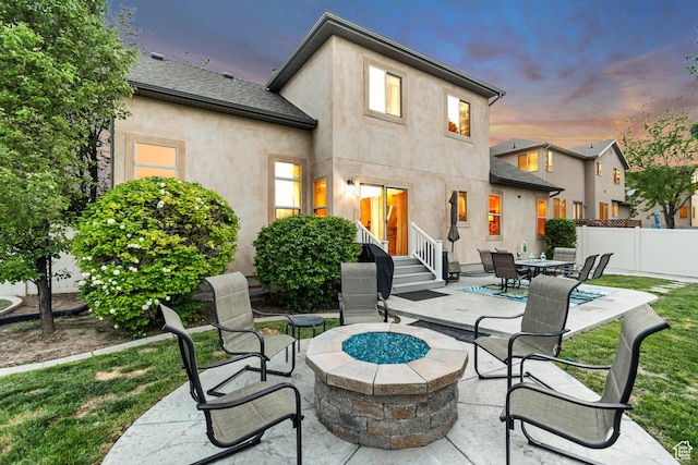 5414 W Island Creek Dr S, West Jordan, UT 84081 - back of property at dusk featuring a fire pit, stucco siding, a patio area, and entry steps