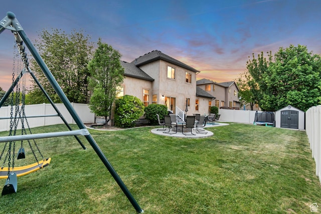 5414 W Island Creek Dr S, West Jordan, UT 84081 - back of property at dusk with a shed, an outbuilding, a patio area, and stucco siding