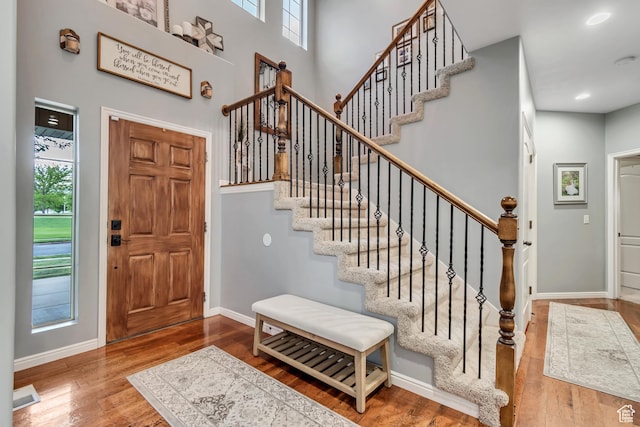 5414 W Island Creek Dr S, West Jordan, UT 84081 - foyer entrance featuring wood finished floors, stairway, baseboards, a towering ceiling, and recessed lighting