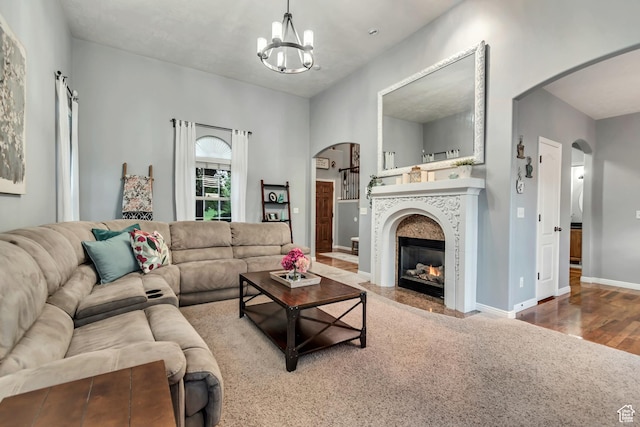 5414 W Island Creek Dr S, West Jordan, UT 84081 - living area with arched walkways, a chandelier, wood finished floors, baseboards, and a fireplace