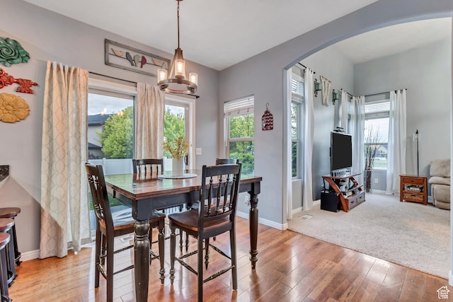5414 W Island Creek Dr S, West Jordan, UT 84081 - dining space with arched walkways, hardwood / wood-style flooring, baseboards, and a chandelier