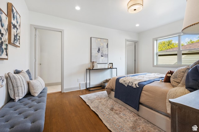 bedroom featuring wood finished floors, recessed lighting, and baseboards