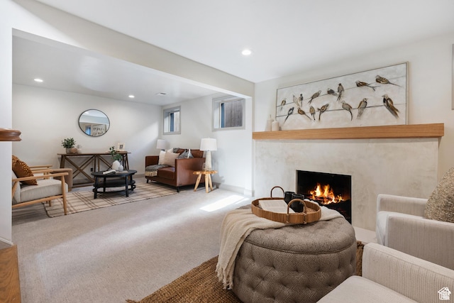 living area featuring a fireplace, carpet flooring, and recessed lighting
